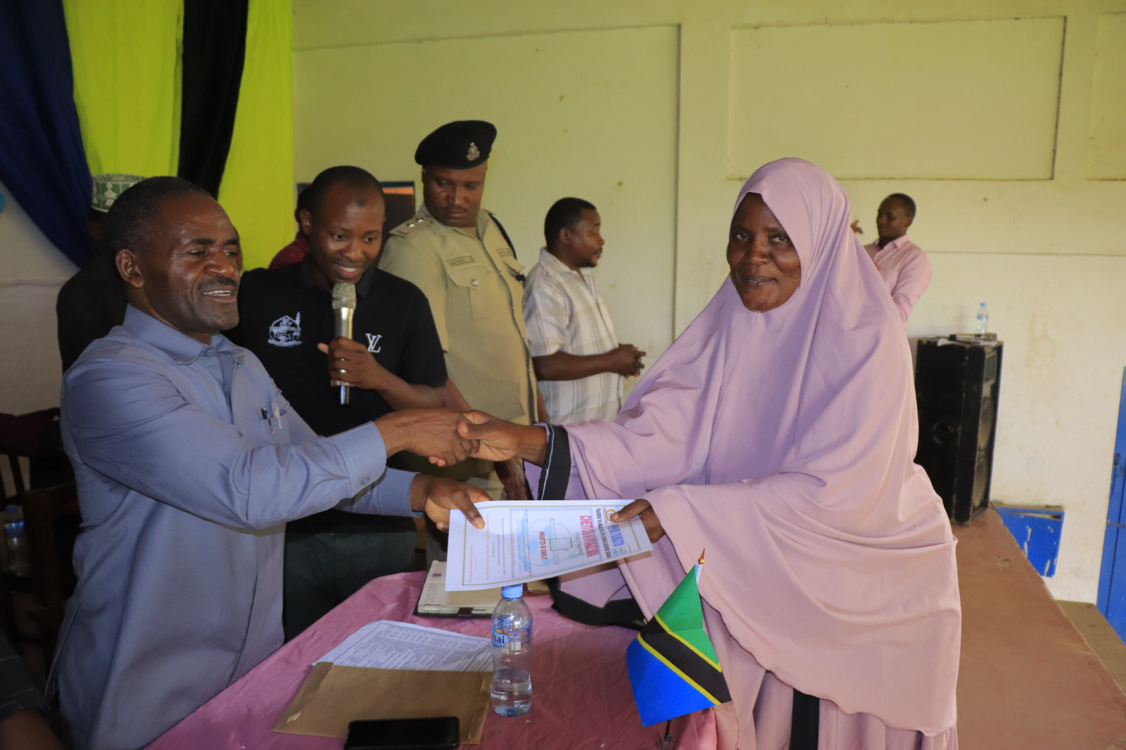 Photos of Mafanikio Foundation volunteers receiving certificates of honor from the Regional Education Officer of Tabora, Mr. Juma Japhet Kaponda, on behalf of the Regional Commissioner of Tabora, for successfully ensuring that all primary school graduates receive special training. Additionally, they launched the campaign "No Child Left Behind - Quality Education for All